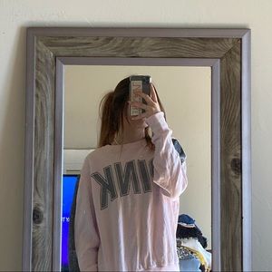 This is a pink shirt with silver lining across the sides of the sleeves!